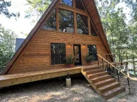 Modern lakefront cabin nestled in the piney woods of East Texas. Pet Friendly! Hotels in Camp County