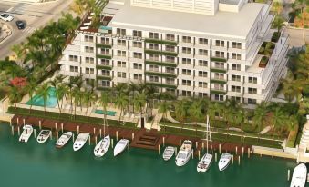 an aerial view of a residential building near a waterfront , featuring multiple boats docked nearby at Grand Beach Hotel Bay Harbor