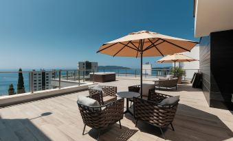 a rooftop patio with several chairs and umbrellas , providing a comfortable space for relaxation and socializing at Sunscape Puerto Plata All Inclusive