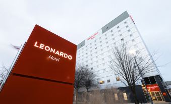 a large red sign for the leonardo hotel is displayed in front of a modern building at Leonardo Hotel Middlesbrough - Formerly Jurys Inn