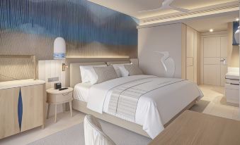 a modern bedroom with a white bed , a nightstand , and a large painting on the wall at Hipotels Flamenco