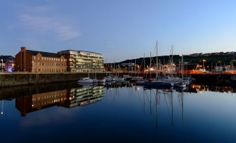 a large body of water with several boats docked at a marina , creating a picturesque scene at The Mansion