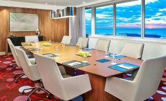 a conference room with a long table and chairs , set up for a meeting at Courtyard Cleveland Elyria