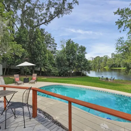 Mid-Century Boho Chic home with Pool, Game Room & Outdoor Playhouse.