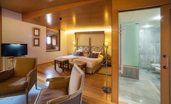 a modern bedroom with wooden floors , white walls , and a bed in the middle of the room at Parador de Santo Estevo