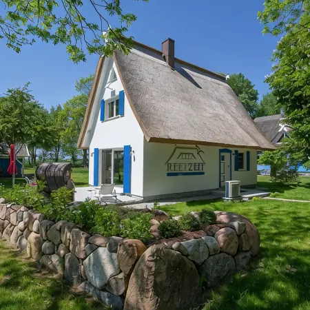 Picturesquely situated thatched-roof house in a large park-like garden