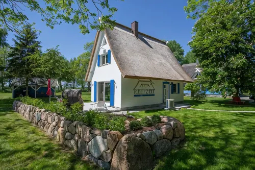 Picturesquely situated thatched-roof house in a large park-like garden