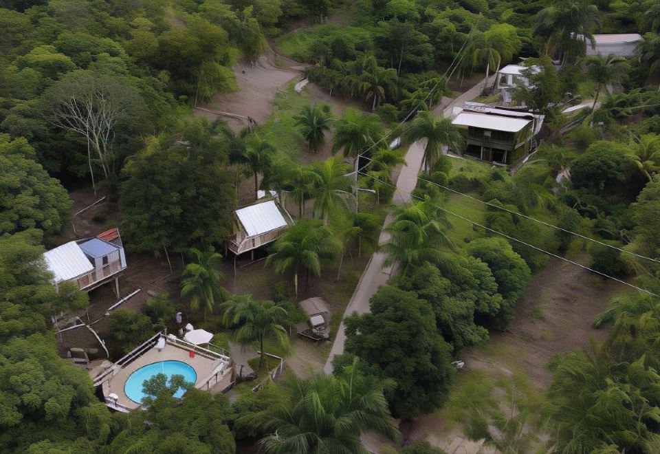 a bird 's eye view of a residential area with houses , trees , and a swimming pool at Hacienda Tres Casitas