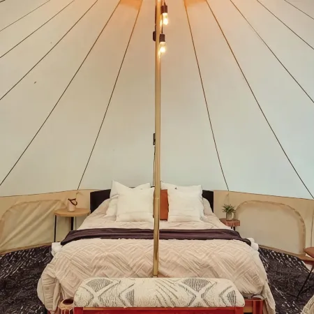 A luxurious glamping tent nestled in the trees.