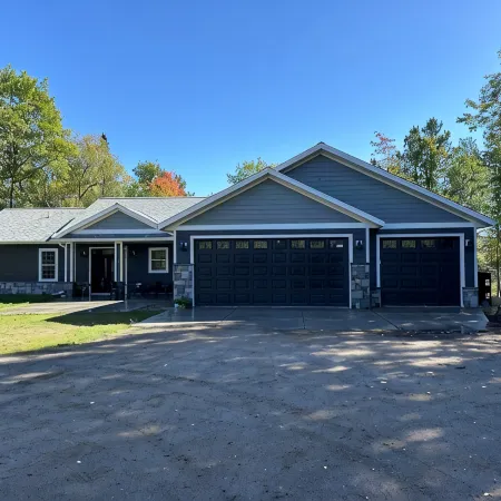 BEAUTIFUL lake front home with a private beach, dock and large yard