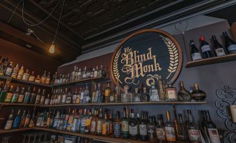 a liquor store with a large collection of liquor bottles displayed on shelves , creating an inviting atmosphere at Hamilton on Beaumont