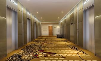 a long hallway with a carpeted floor and several doors , one of which is open at Sunway Lagoon Hotel , Formerly Sunway Clio Hotel