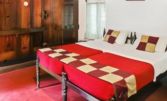 a red and gold bed with two beds on either side , one of which is a bunk bed at Emerald Isle