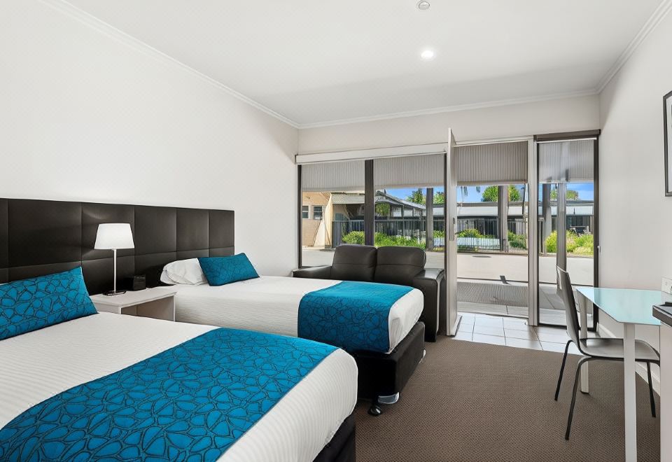 a hotel room with two beds , one on the left and one on the right side of the room at Comfort Inn & Suites Manhattan