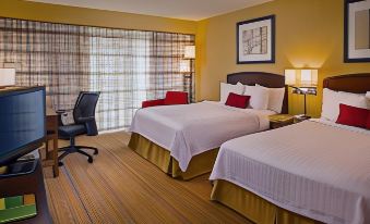 a hotel room with two beds , a window , and a desk , all set against a yellow background at Courtyard Richmond Northwest/Short Pump