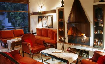 a cozy living room with various furniture , including a couch , chairs , and a fireplace , creating a warm and inviting atmosphere at Aspen Hotel