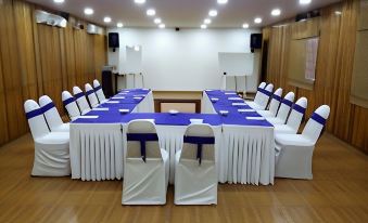 a large conference room with multiple chairs arranged in a semicircle , providing seating for a group of people at Bluebay Beach Resort