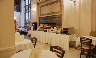 a dining room with a large buffet table filled with a variety of food and drinks at Comfort Inn & Suites Manhattan