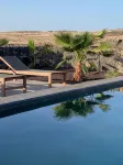 An architectural oasis with large swimming pool, along a breath-taking scenery. - Huvilat