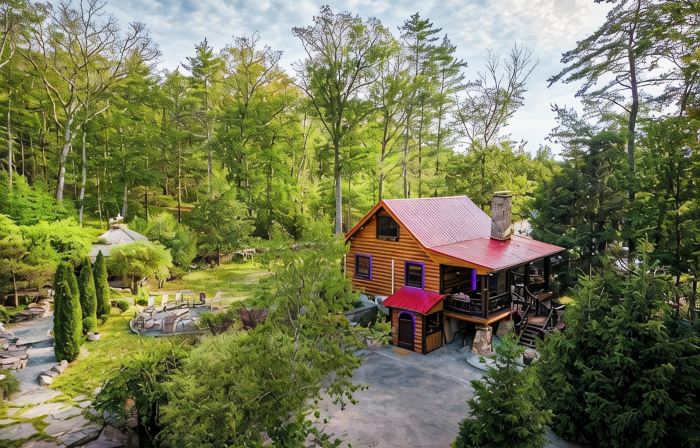 Private log cabin nestled at the base of a secluded wooded area
