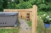 Charming 2-bedroom apartment with outdoor hot tub in rural area, private yard.