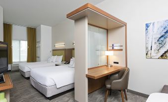 a modern hotel room with two beds , a desk , and a chair , all neatly arranged in the space at SpringHill Suites Detroit Auburn Hills