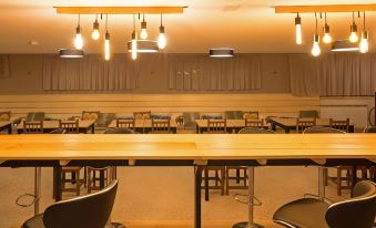 a large dining area with several tables and chairs , some of which are made of wood at Hotel Austria