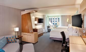 a modern hotel room with a large bed , desk , and window , along with various amenities at Courtyard Yonkers Westchester County