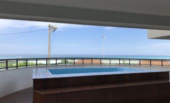a rooftop bar with a pool overlooking the ocean , creating a serene and relaxing atmosphere at Sophia II Residence Inn