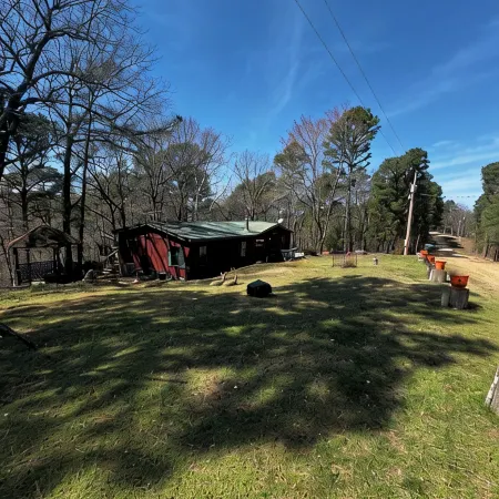 Quiet cabin in the woods w/ access to pools, river, & lakes in gated community!!