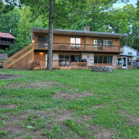 Spacious and cozy home with gas fireplace, boat dock, and lake views