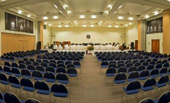 a large conference room with rows of chairs and a stage set up for a band performance at Hotel Marbella