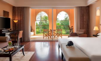 a hotel room with a large window overlooking a golf course , providing a view of the golf course at Tikida Golf Palace