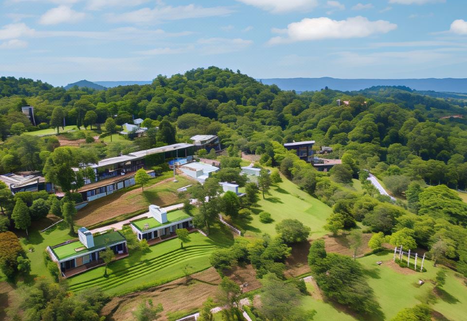 aerial view of a golf course surrounded by trees , with multiple houses in the background at Veravian Resort