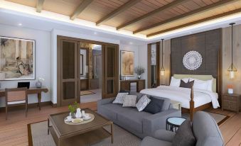 a modern bedroom with a large bed , couch , and coffee table , as well as a bathroom nearby at Plataran Bromo