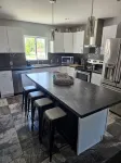 Spacious home near Torch Lake w/custom back patio, steps away from public access - 4-Star