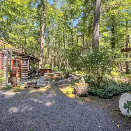 Rustic Rest Log Cabin, with hot tub and trout stream, near Poconos attractions.