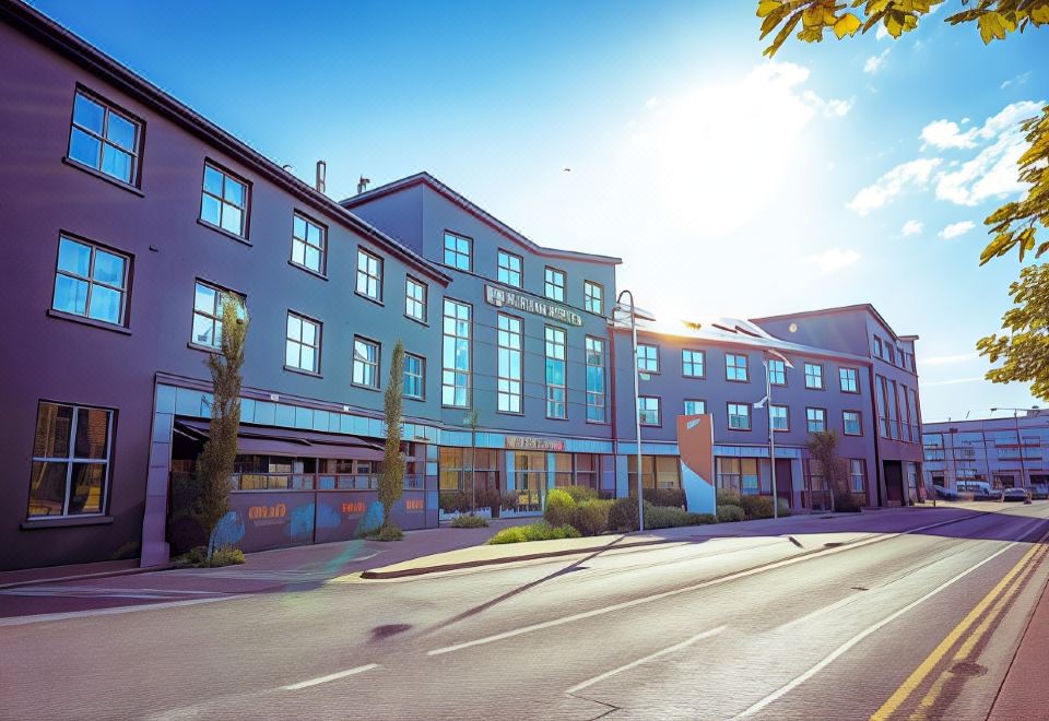 a modern building with multiple floors , situated on a street corner near a city street at Harbour Hotel