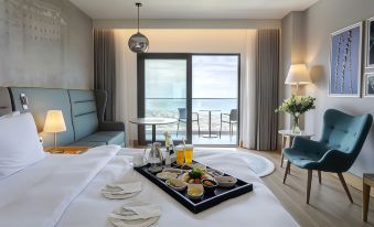 a hotel room with a bed , table , and sliding glass door leading to a balcony at Radisson Blu Hotel Trabzon