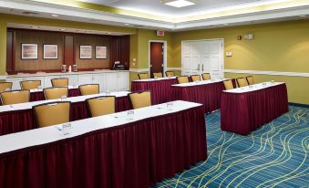 a conference room set up for a meeting , with tables and chairs arranged in rows at Staybridge Suites Pittsburgh Airport