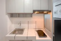Combined Grey Toned 2BR Apartment at The City Square Surabaya By Travelio