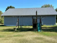BEAUTIFUL lake front home with a private beach, dock and large yard