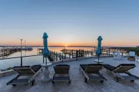 Waterfront home with dock, heated pool, & spectacular views- walk/bike downtown!