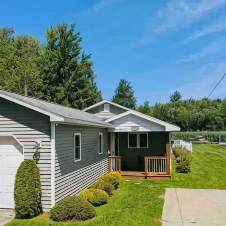 Spacious 4-bedroom waterfront house in Sylvan Beach with private yard and dock.