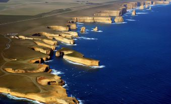 aerial view of the twelve apostles , a series of sandstone formations in australia , with the ocean below at Seahorse Coastal Villas