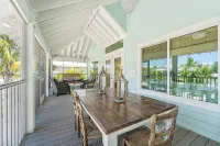 Charming cottage with heated pool, tropical landscaping in prime location.