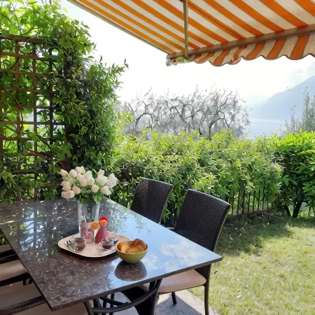 Apartment Agnese with lake view, swimming pool, garage and private garden.