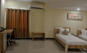 a hotel room with a bed , curtains , and an air conditioner , along with a table and stool at My Inn Hotel Kota Samarahan