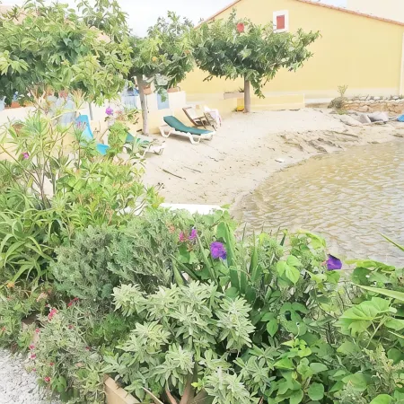 House on the edge of a marine pond close to the beach