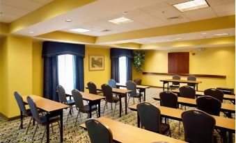 a large conference room with multiple tables and chairs arranged for a meeting or training session at Hampton Inn & Suites Lake Wales